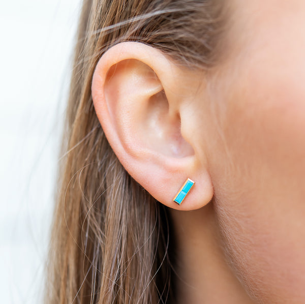 These modern beauties feature two faceted turquoise baguettes encased in a 14k yellow gold bezel on each ear. These are the perfect casual earring for those days at the ballpark or nights out with the family eating together. It also looks great in a second or third ear piercing!