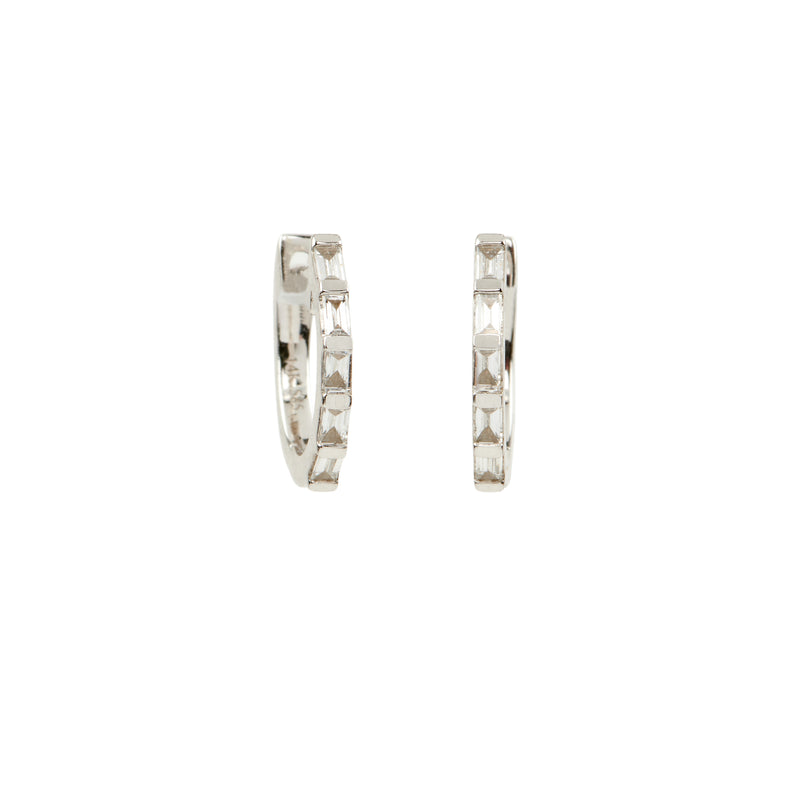 When you want a modern take on a pure classic, these unique 'huggie" hoop earrings featuring diamond baguettes are the way to go. These are an easy every day piece that you're sure to love as much with workout clothes as you do with a sleek black top and jeans. If you want to take it up a notch, simply add some of our charm drops for a pop of color or some additional sparkling diamonds. However you wear them, you're sure to get compliments!