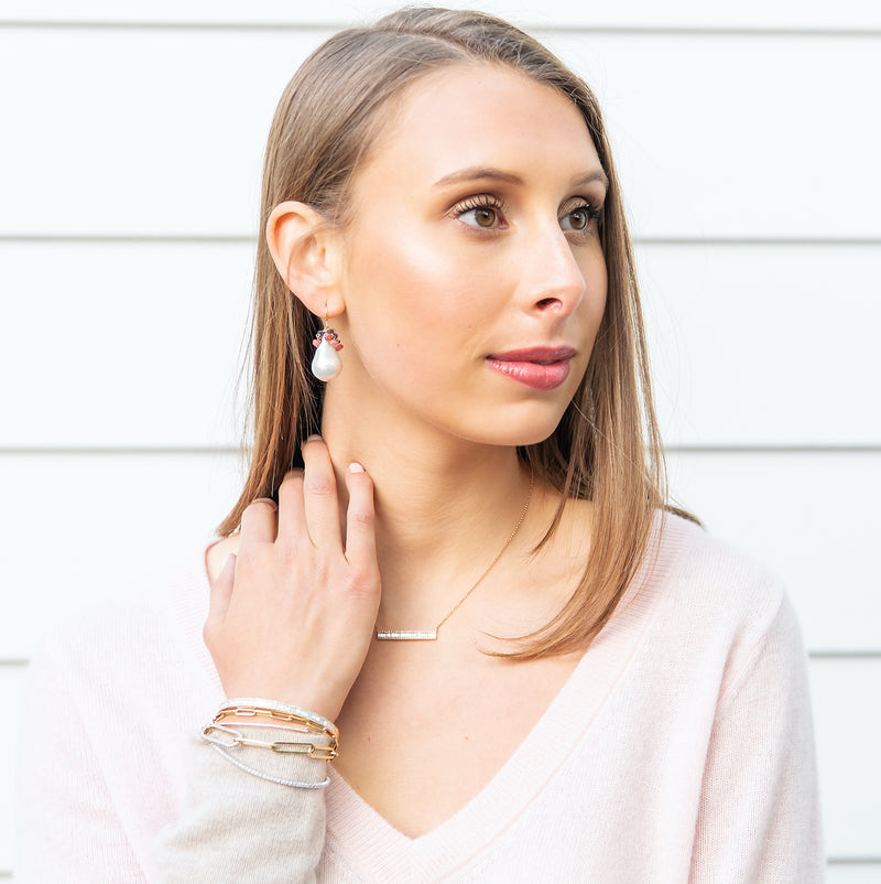 Simple + Beautiful. These gorgeous white baroque freshwater pearls are accented by a cascade of pink ruby and blue sapphire roundels. These are gorgeous!